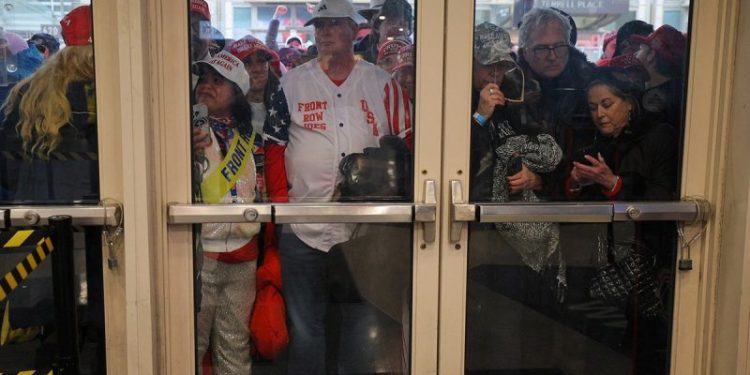 Trump fans endure frigid temps, sleet and snow for a chance to see president-elect