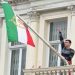 Protester scales Iranian Embassy in London, tears down regime flag, hoists pre-revolution symbol